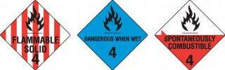 Flammable Solids Warning Signs Three hazardous material placards: "Flammable Solid," "Dangerous When Wet," and "Spontaneously Combustible," each with a flame icon and classification number 4.
